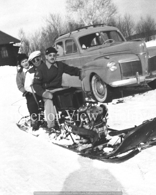 3 People on Old Snowmobile